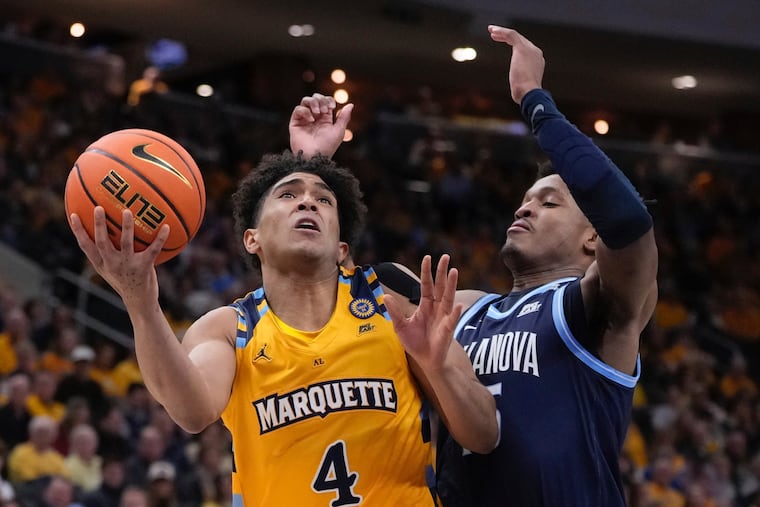 Marquette's Stevie Mitchell (left) shoots past Villanova's Wooga Poplar during the first half Friday night.