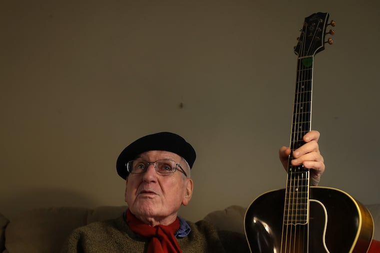 Marty Grosz, legendary Philly jazz guitarist, talks about his music career as he holds his vintage Gibson guitar at his home in Philadelphia, PA on February 26, 2020. Grosz, 89, says he plays every day.