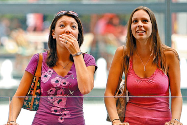 Rhiana Pettenati of Duncansville, Pa., who was visiting childhood friend Michelle Davis (right), who recently moved to Philadelphia, was told to go see what 30 million tiny lightbulbs can do at the Comcast Center. Michelle Gailey of Gallitzin, Pa., was with them.