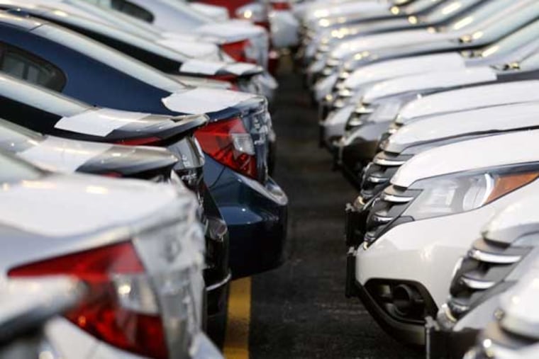 In this Wednesday, Dec. 5, 2012, photo, Honda Civic and Honda CRVs are seen outside of a Honda car dealership in Des Plaines, Ill. The U.S. auto industry ended 2012 on a high note, with December sales the strongest they have been since before the recession. Analysts predict an even bigger year in 2013, as a stronger economy, low-interest rates, aging cars on the road and competitive new products continue to draw buyers to dealerships. (AP Photo/Nam Y. Huh)