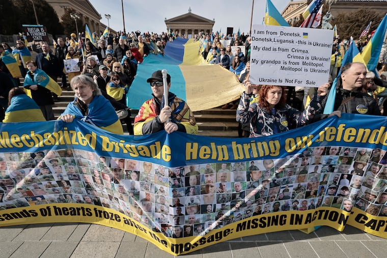 Supporters of Ukraine held a large Ukrainian flag during a rally at the Philadelphia Museum of Art before a march to City Hall on Sunday. The demonstration marked the three-year anniversary of Russia's invasion of Ukraine.