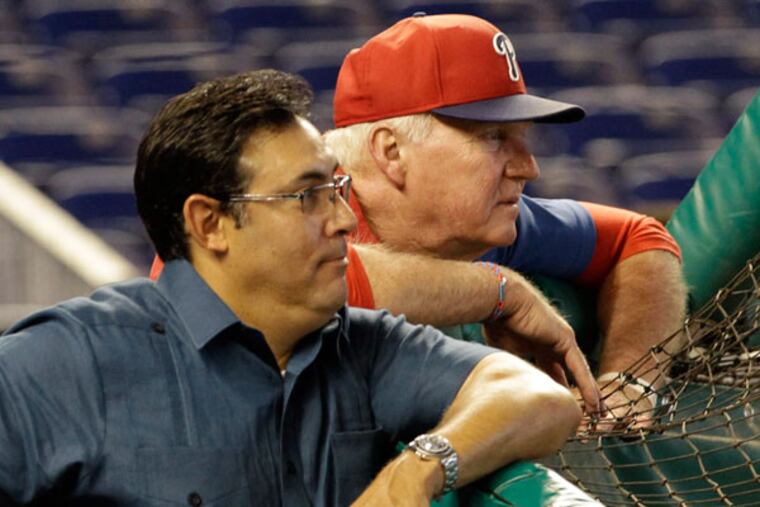 Philadelphia Phillies manager Charlie Manuel, right, and general manager Ruben Amaro, Jr. watch batting practice before an MLB baseball game against the Miami Marlins in Miami, Saturday, April 13, 2013. (Alan Diaz/AP)