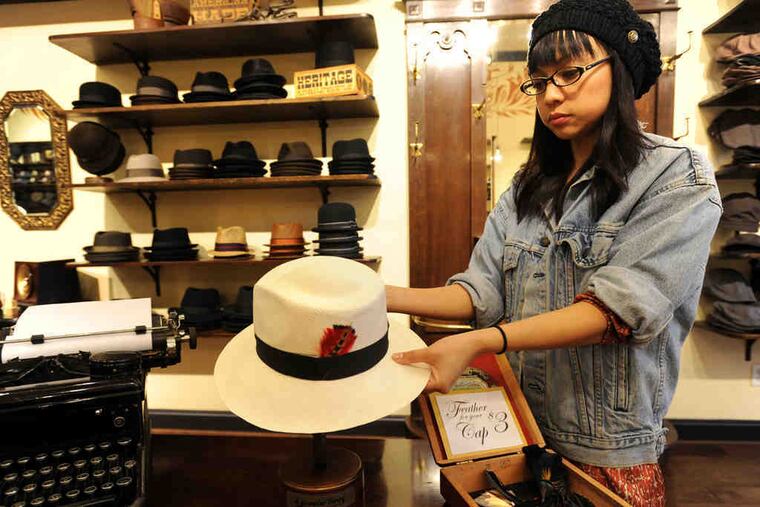 Store manager Macy Torres holds a traditional Panama hat at the Goorin Bros. shop in Berkeley, Calif. Hats are a fashion accessory now, she says, "and in a tough economy, it makes a lot more sense to buy a $45 hat than an expensive suit."