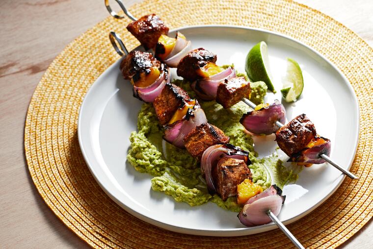 Chili-lime pork and mango skewers with avocado mash.