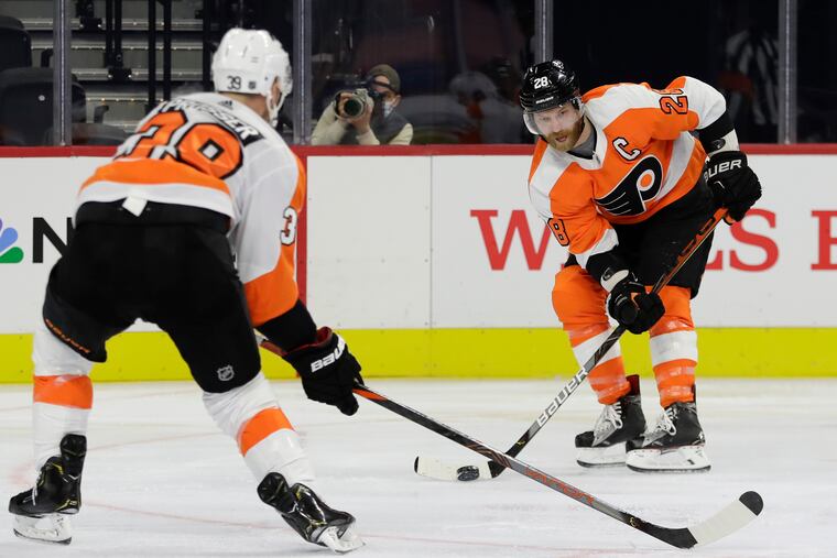 Flyers left winger Claude Giroux (right) skates the puck against defenseman Nate Prosser during an intrasquad game Jan. 10. Prosser made his Flyers debut Thursday in New Jersey.
