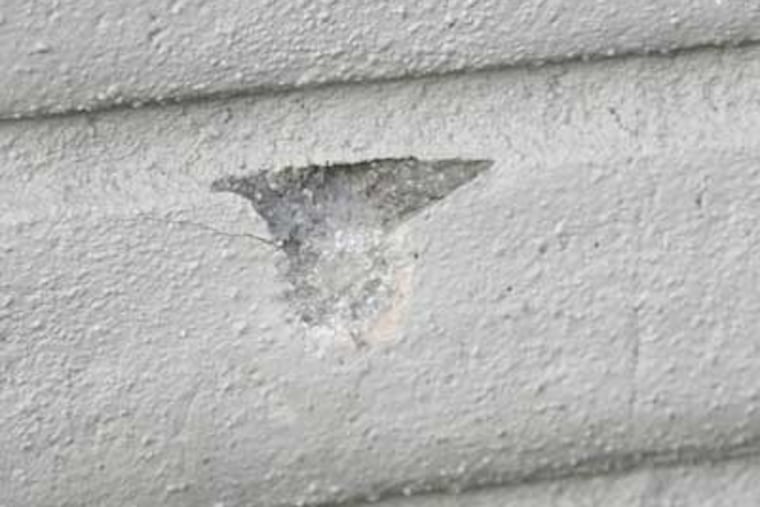 Damage caused by gunfire aimed at the office building for Mystical LLC, a tow truck company in the Olney section of Philadelphia. (Alejandro A. Alvarez / Staff Photographer)