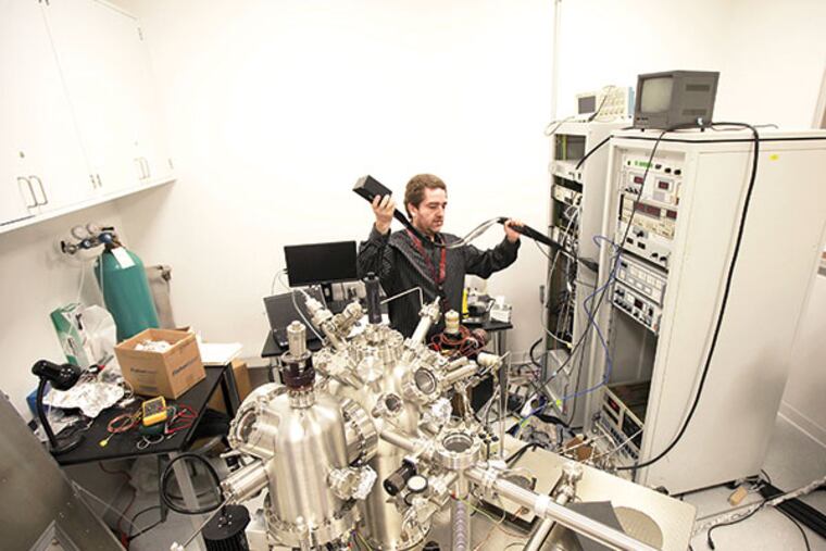 Erie Morales works with a OMICRON VT-AFM/STM microscope at the Singh Center for Nanotechnology, Friday September 20, 2013. ( DAVID SWANSON / Staff Photographer )