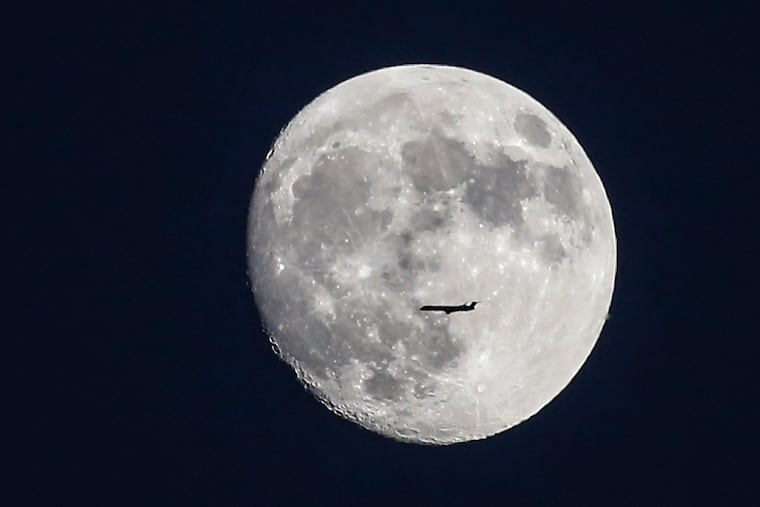 A commercial airliner flies in the foreground the waxing "Super Moon" in July. This should be quite the holiday weekend for lunar connoisseurs.