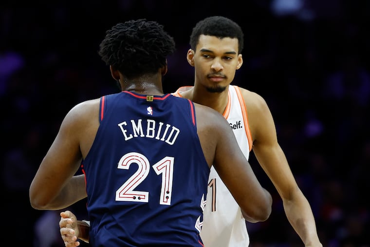 Spurs rookie center Victor Wembanyama and Joel Embiid meet before tipoff on Monday. At 7-foot-4, the French rookie is among the few who are taller than the Sixers' star big man.