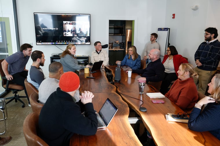 Founding Chatham Financial chief executive and Square Roots Collective founder Michael Bontrager, center, flanked by his daughters, at a weekly team meeting in Kennett Square in January.