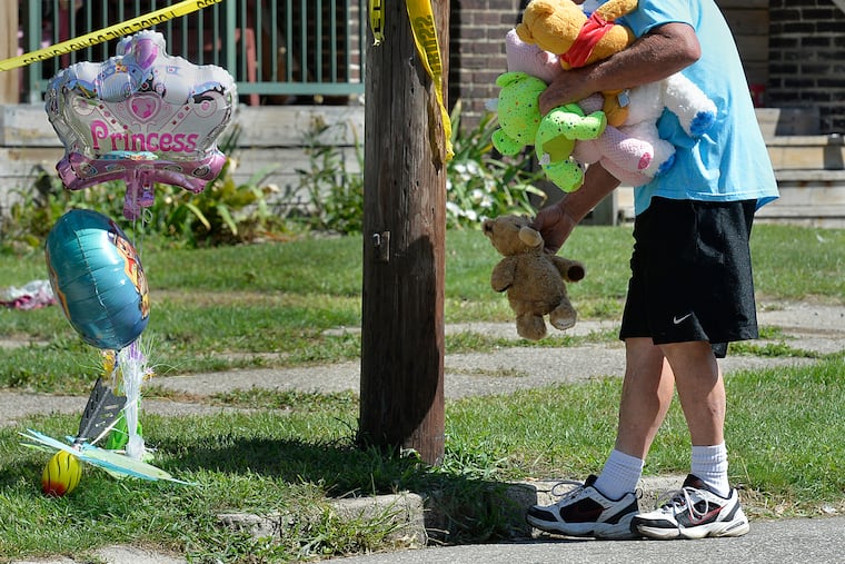 Paul Laughlin, 57, places stuffed animals on Sunday, Aug. 11, 2019 outside a home at 1248 West 11th St. in Erie, Pa., where multiple people died in an early-morning fire.