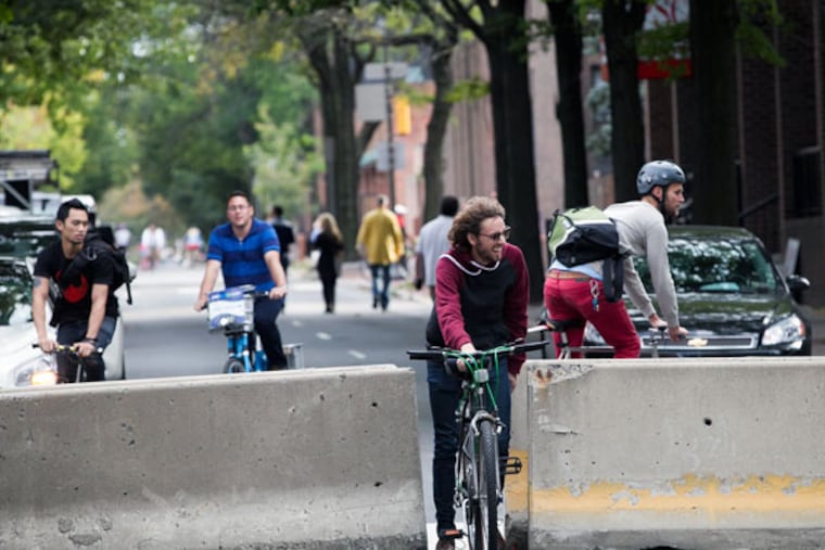 Bicyclists ride along the empty streets in Center City during the pope’s visit. (ALEJANDRO A. ALVAREZ/STAFF PHOTOGRAPHER)