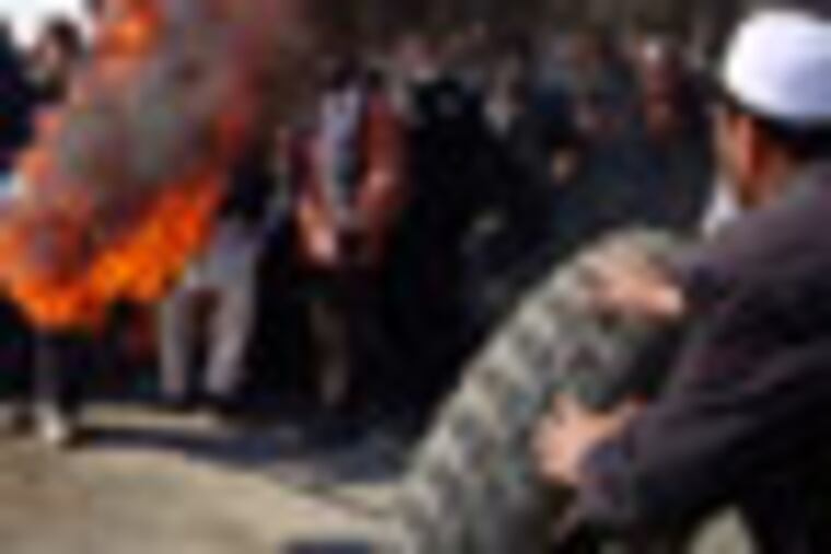 Afghans burn tires during an anti-U.S. demonstration over burning of Qurans at a US military base, in Muhammad Agha, Logar province south of Kabul, Afghanistan, Saturday, Feb. 25, 2012. (AP Photo/Obaid Ormur)
