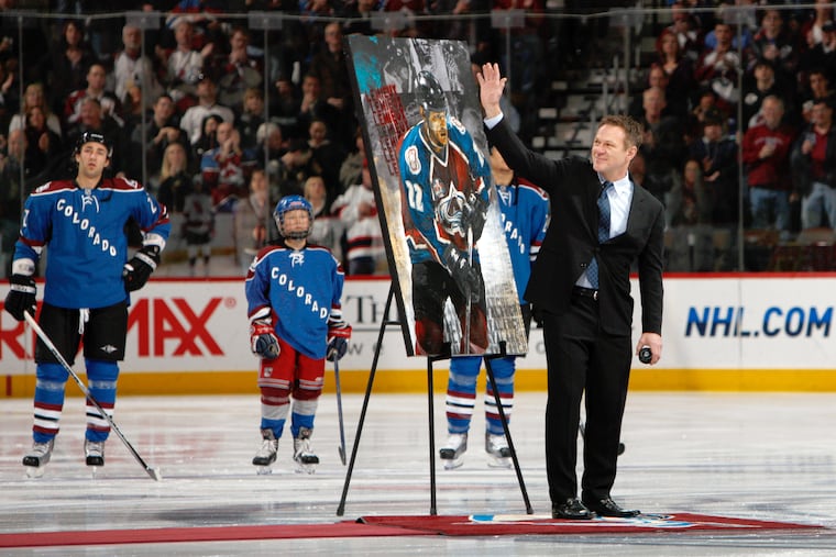 Retired Colorado Avalanche player Claude Lemieux waves to fans as he is honored for his years on the ice before the Avalanche host the New Jersey Devils in 2010.
