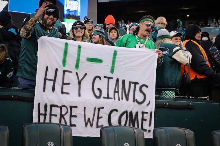 Fans hold up a sign for their next opponent, the Giants, after the Eagles beat the Titans 35-10 in Philly in 2022.