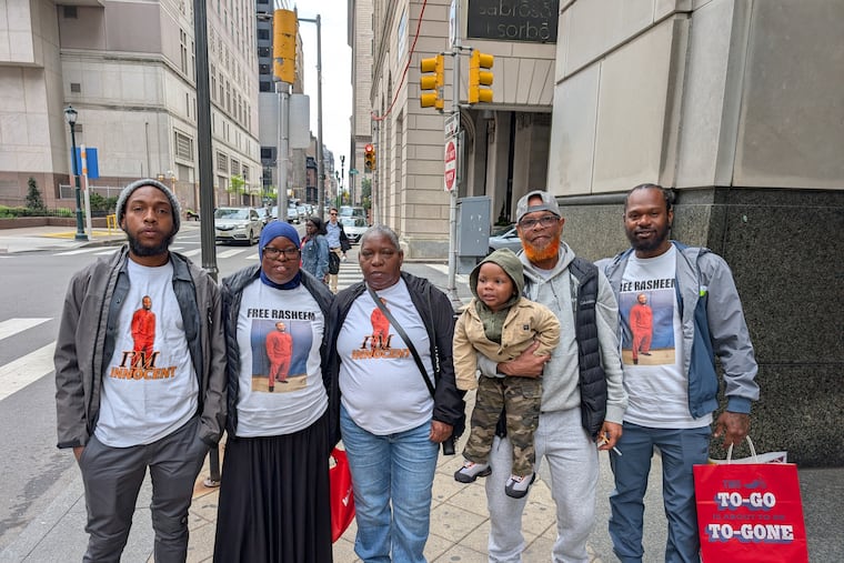 Rasheem Hall's father, Ronald, (second from right) and other members of Hall's family celebrate the judge's ruling outside Philadelphia Common Pleas Court in Philadelphia on Wednesday.