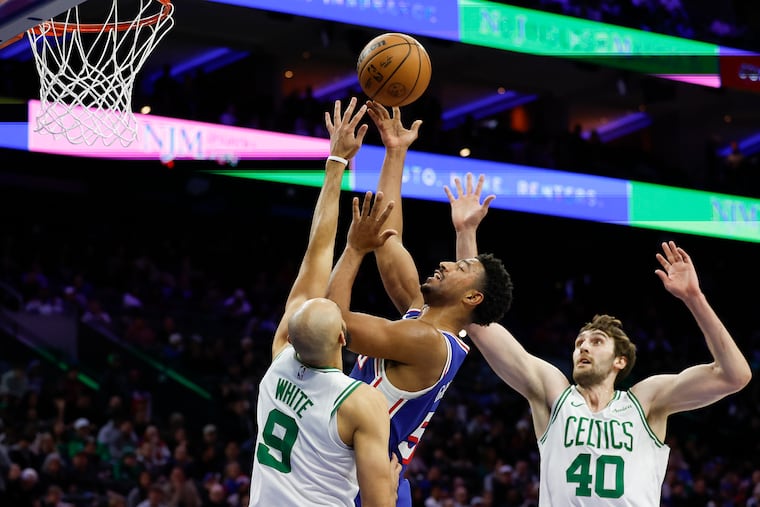 Sixers guard Quentin Grimes drives against Boston Celtics guard Derrick White and center Luke Kornet. Grimes, making his second consecutive start, had 12 points in the loss to the Celtics.