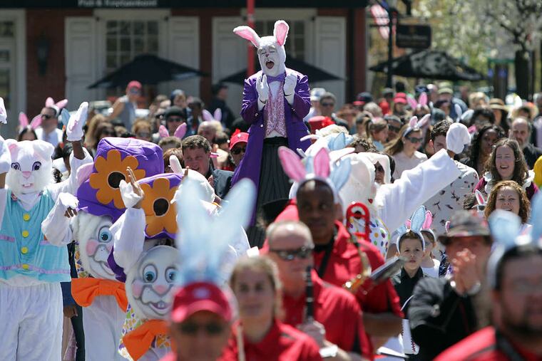 Dale Varga of South Philadelphia, dressed as an Easter Bunny on stilts, celebrates with the crowd.