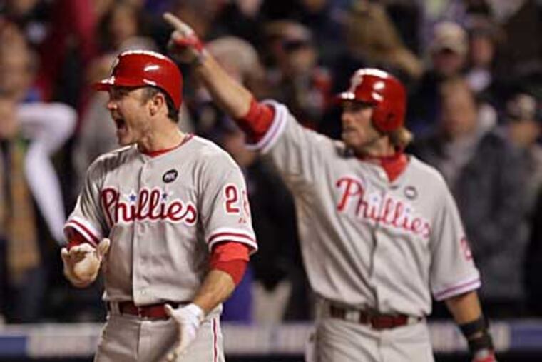 Chase Utley and Jayson Werth celebrate Ryan Howard's game-tying double in the ninth inning during Monday's come-from-behind victory over the Rockies. (Yong Kim / Staff Photographer)