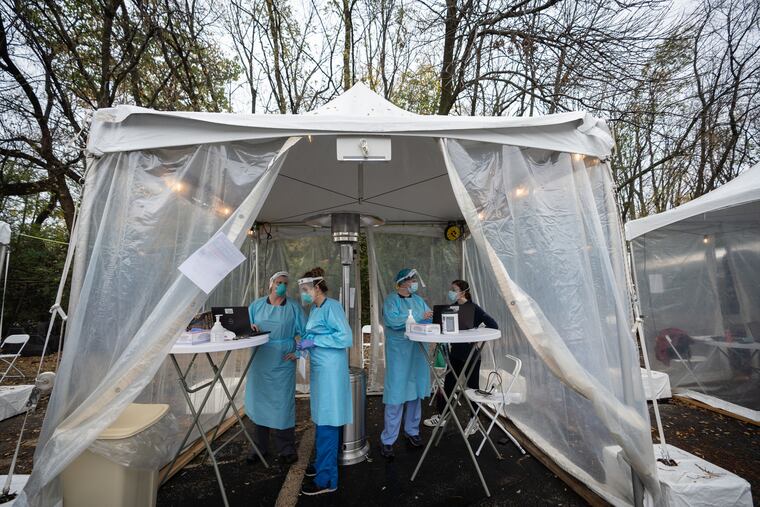 Cara Grugan, physician assistant, Anna Schenker, registered nurse, Lisa Tucciarone, nurse practitioner, and Nicole Nester, site coordinator and research fellow at Jefferson Health testing lab, work at a new Jefferson Health coronavirus testing site in the parking lot of Richard Allen Preparatory Charter School, in Southwest Philadelphia. Testing at this site is at no cost and does not require a prescription or an appointment.