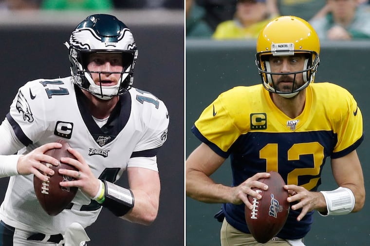 Quarterbacks Carson Wentz, left, and Aaron Rodgers.