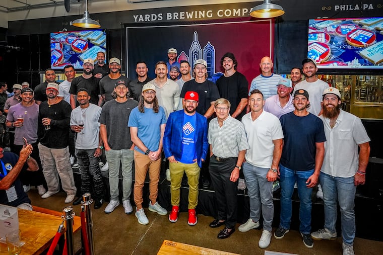 Kyle Schwarber (center) shown with his Phillies teammates, who showed up at his third annual Schwarber's Block Party.