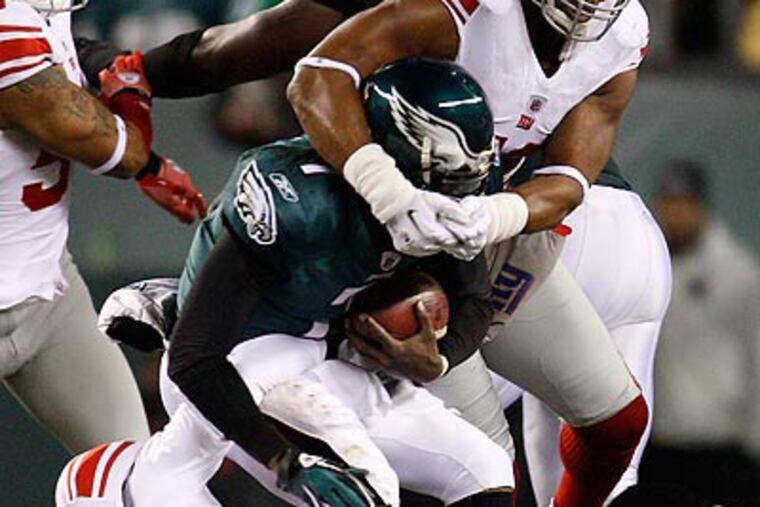 Michael Vick was sacked three times in the Eagles' win over the Giants. (David Maialetti/Staff Photographer)
