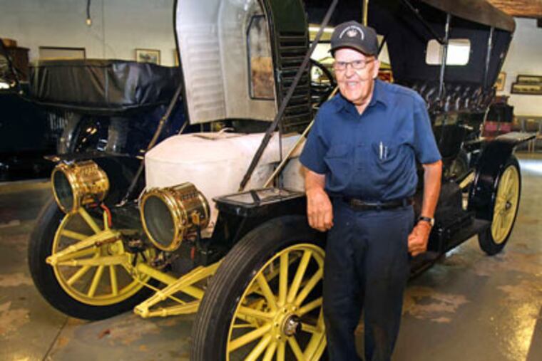 Tom Marshall stands next to a 1910 Stanley Steamer, one of 15 in his collection. RON CORTES / Staff Photographer