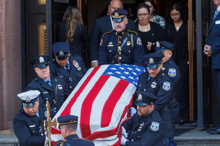 The coffin of Philadelphia Police Officer Richard Mendez leaves the cathedral following his funeral service. Mendez was shot and killed in a parking garage at Philadelphia International Airport on Oct. 12.