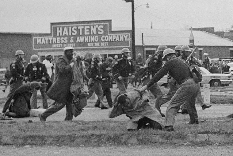 State troopers swing billy clubs to break up a civil rights voting march in Selma, Ala., on March 7, 1965.