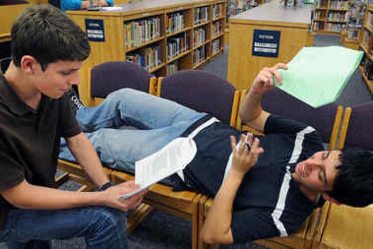 Going over their lines at a rehearsal are Alex Faye (left) and Eli Goldberg. The group's production, "Death by Shakespeare," combines three Shakespearean death scenes connected by an original narrative of detectives on the case.