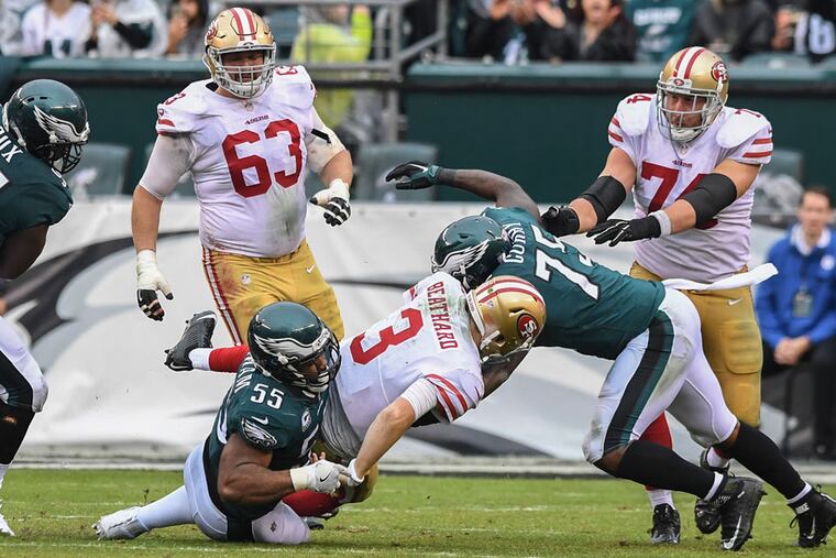 Eagles defensive ends Brandon Graham and Vinny Curry sack San Francisco quarterback C.J. Beathard for a six-yard loss during a game at Lincoln Financial Field on October 29, 2017.