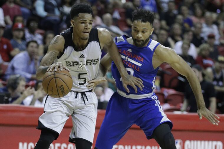 Sixers summer league guard James Blackmon (right) defends San Antonio Spurs’ rookie Dejounte Murray. Blackmon is battling for a roster spot.
