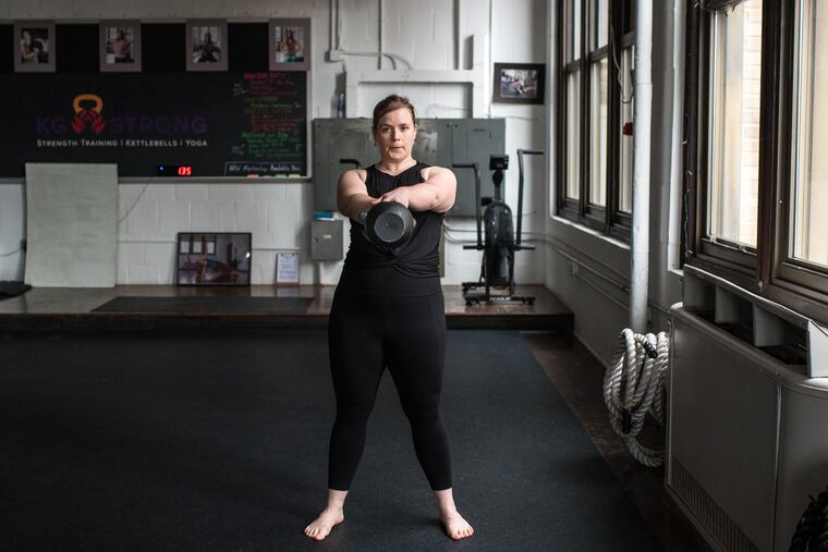 Chef Kelsey Bush of Bloomsday Café demonstrates a kettlebell swing at KG Strong, where she works out with a personal trainer for an hour each week.