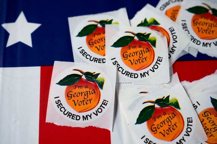 Stickers sit on a table inside a polling place, Nov. 5, 2024, in Atlanta. (AP