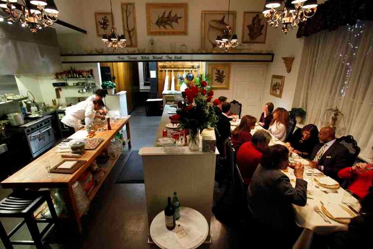 At Under the Oak Cafe, diners are seated for the weekly chef's table dinner. The BYOB meal consists of eight courses.