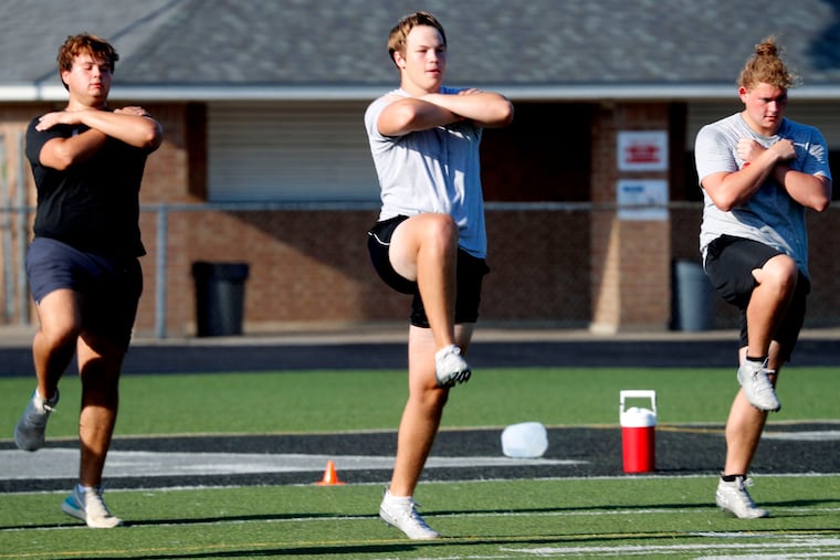 With social distancing in mind, student athletes run a drill during the re-opening of a strength and conditioning camp at Arlington Martin High School in Arlington, Texas, in June.