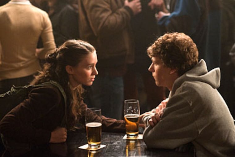 Rooney Mara, Jesse Eisenberg (as Facebook creator Mark Zuckerberg) meet in a Boston bar. She dumps him; he heads to his computer.