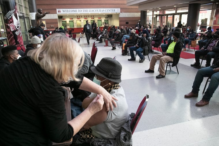 Sue Leimbach, RN, administers a COVID-19 vaccine during the Black Doctors COVID-19 Consortium’s 24-hour, walk-up vaccination site inside the Liacouras Center in Philadelphia on Feb. 19, 2021. This is the city’s first 24-hour walk-up vaccination site, which began on noon Friday and will continue through noon Saturday.