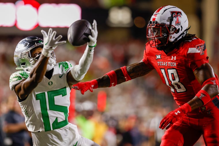 Texas Tech defensive back Tyler Owens defends Oregon wide receiver Tez Johnson during the Ducks' 38-30 victory on Saturday in Lubbock, Texas.