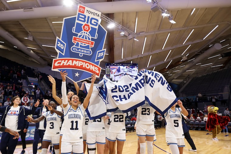 Villanova guard Jasmine Bascoe (11) holds a sign after winning the Big 5 women's championship against St. Joe's on Sunday.