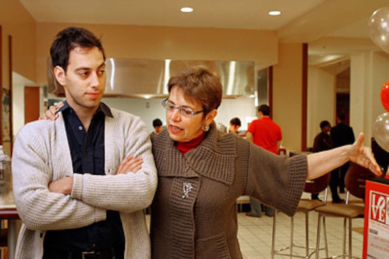 Laura Fattal, mother of Josh Fattal who has been held by Iran since July 2009, puts her arm around her son, Alex, and extends her empty arm while saying there's an empty space where Josh should be. (Laurence Kesterson / Staff Photographer)