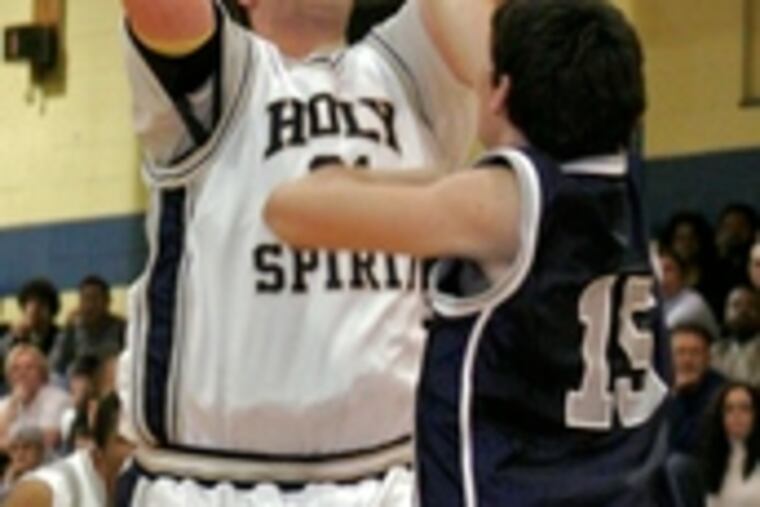Holy Spirit's Matt DeSouza gets off a shot over St. Augustine defender Bill Giberson. DeSouza scored nine points in the win, which kept the Spartans perfect at 13-0, 4-0 in league play. The Hermits fell to 9-2, 3-1.