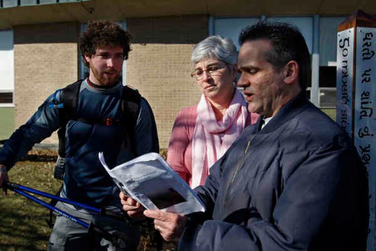 Dennis Quinn watches his mother Denise Quinn and teacher Joe Pisacano read poems written by Kyle Quinn to fifth graders at McDonald Elementary in Warminster.