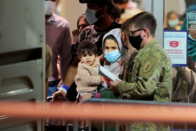 On Tuesday both houses of Congress prepared to consider the Afghan Adjustment Act, which would provide a pathway to citizenship for wartime allies who were evacuated to the United States amid the U.S. military with drawl. Here newly arrived evacuees wait to board buses parked behind Terminal A East baggage area at Philadelphia International Airport shortly after 5 a.m. on Aug. 30, 2021. Thousands fled Taliban rule in Afghanistan.