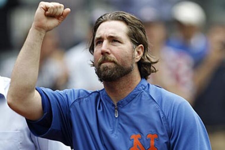 R.A. Dickey and the Blue Jays agreed to a new contract Monday, clearing the way for the New York Mets to trade the NL Cy Young winner to a Toronto. (Kathy Willens/AP file photo)