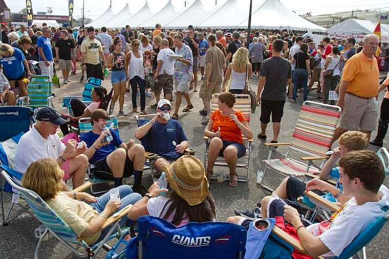 Families set up chairs outside the tasting tents at the 25th annual Chowderfest on Long Beach Island. The annual cook-off offers a variety of clam chowders for people to vote on. (David M Warren/Staff)
