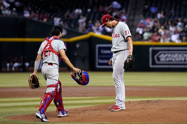 Philadelphia Phillies starting pitcher Aaron Nola (27) gets a visit from catcher Garrett Stubbs in the second inning Tuesday.