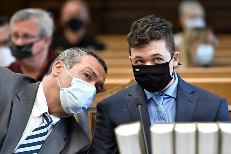 In this May 21 photo, Kyle Rittenhouse (right) listens to his attorney, Mark Richards, during Rittenhouse's pretrial hearing at the Kenosha County Courthouse in Kenosha, Wis.
