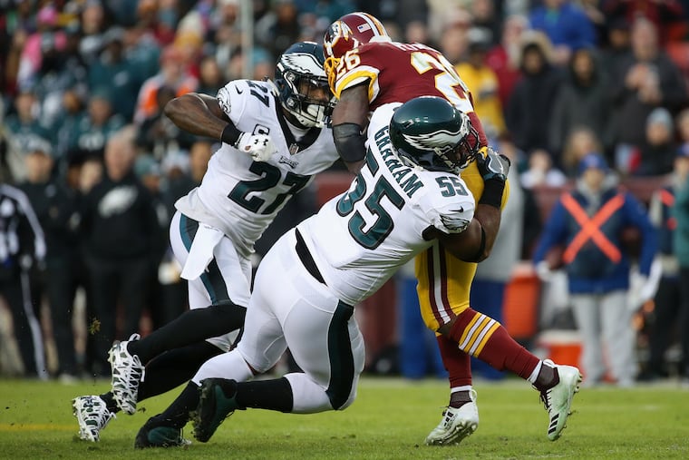 Eagles defensive end Brandon Graham (55) tackles Redskins running back Adrian Peterson during last December's game at FedEx Field.